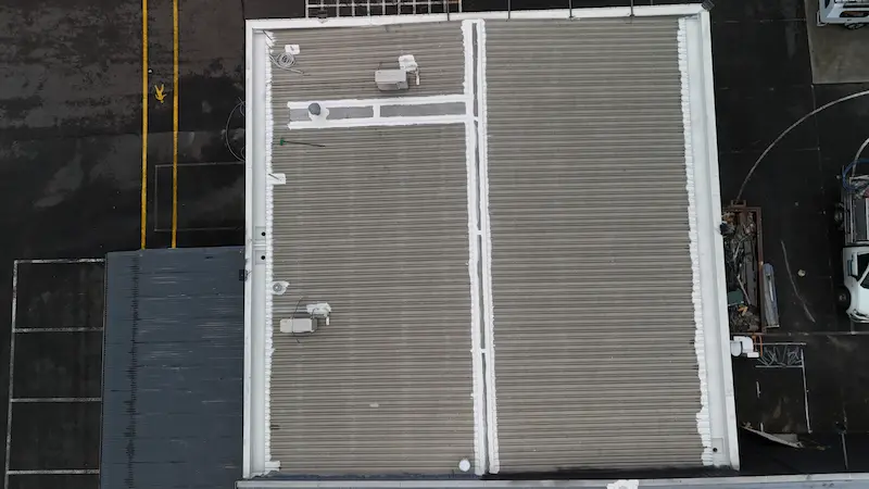 Applying Noxyde membrane to protect roof from rust and water damage