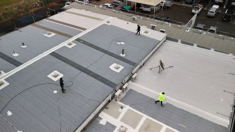 Applying Dulux Primer on Lilydale School roof to prepare for topcoats