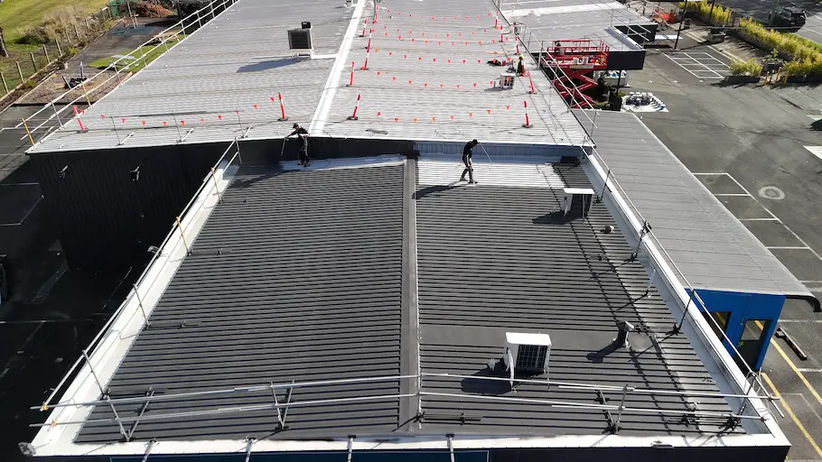 Protective Dulux Topcoat applied during commercial roof painting for rust and water protection