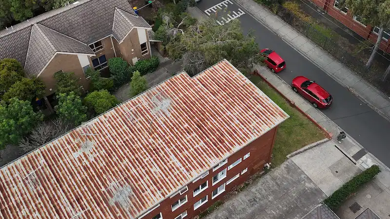Rusted commercial metal roof in Peel St Kew before restoration and waterproofing work.