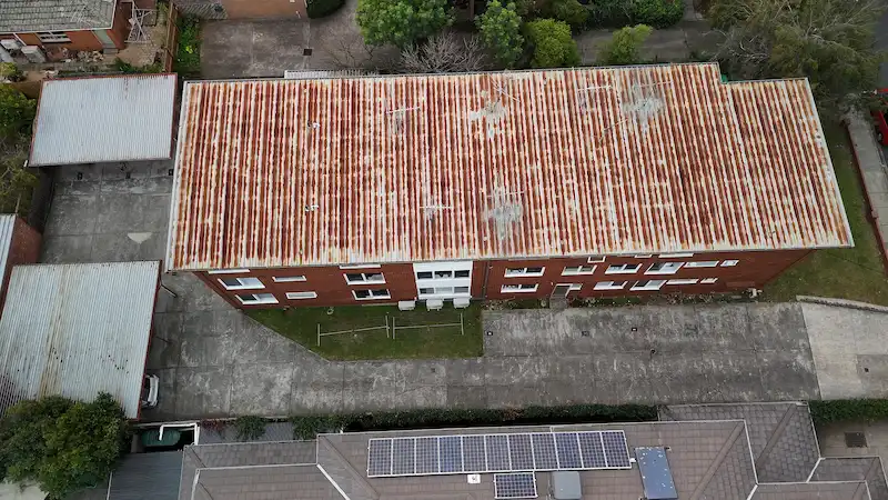 Rusted commercial metal roof before MPC restoration and waterproofing work.