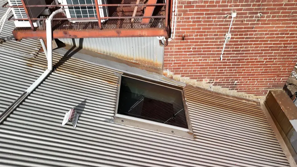 Skylight and roof junction showing water ingress issues on commercial building