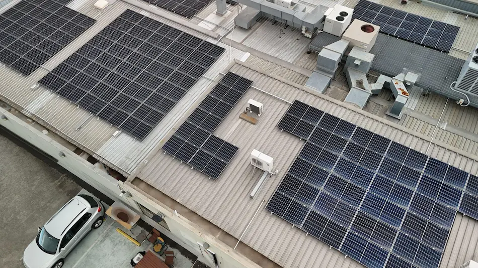 Metal roof with solar panels before waterproofing in Brighton