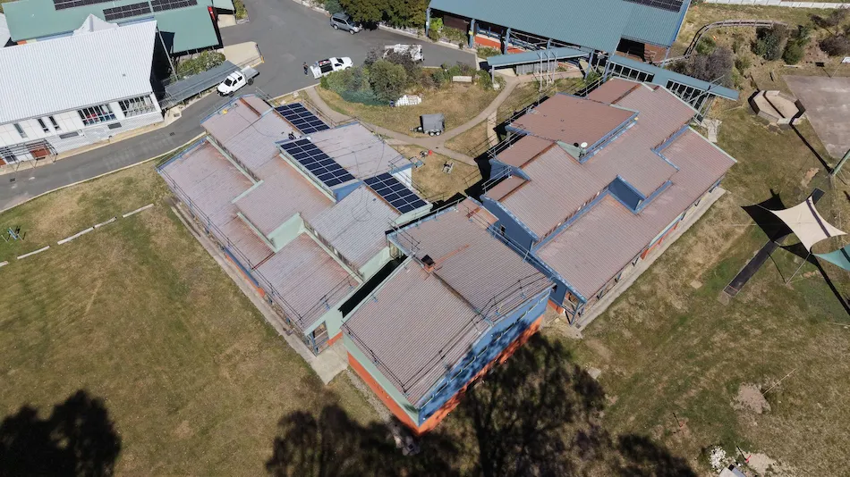 Aerial view of Howmans Gap Alpine Centre roof in Falls Creek before restoration