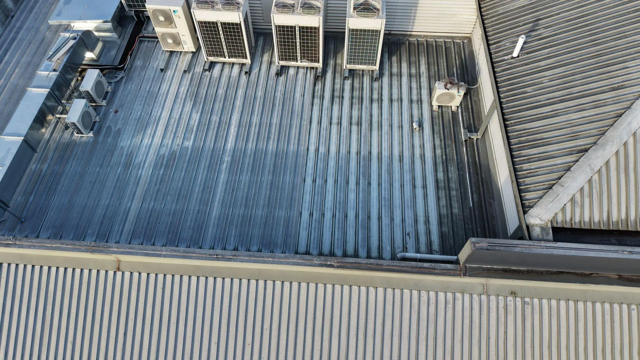 Commercial roof in Sydney showing aging metal surface before waterproofing membrane